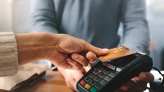 Photo of woman paying with card