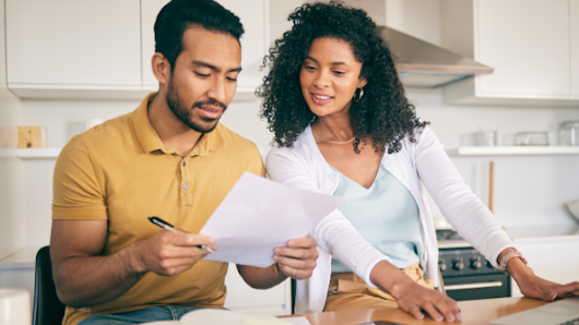 Photo of a couple looking at insurance papers