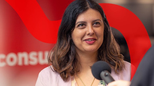 Young boy sticking drawing to window.
