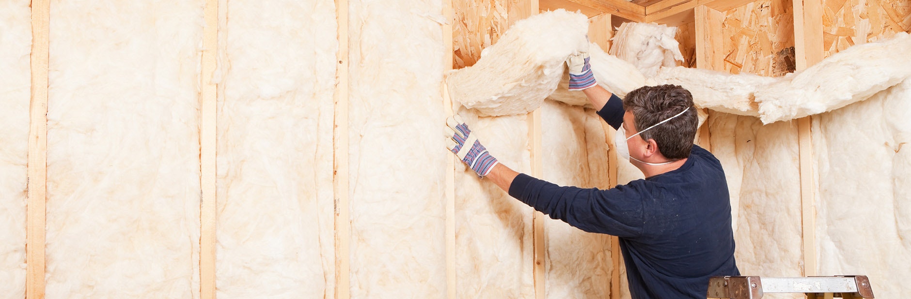Man insulating a wall