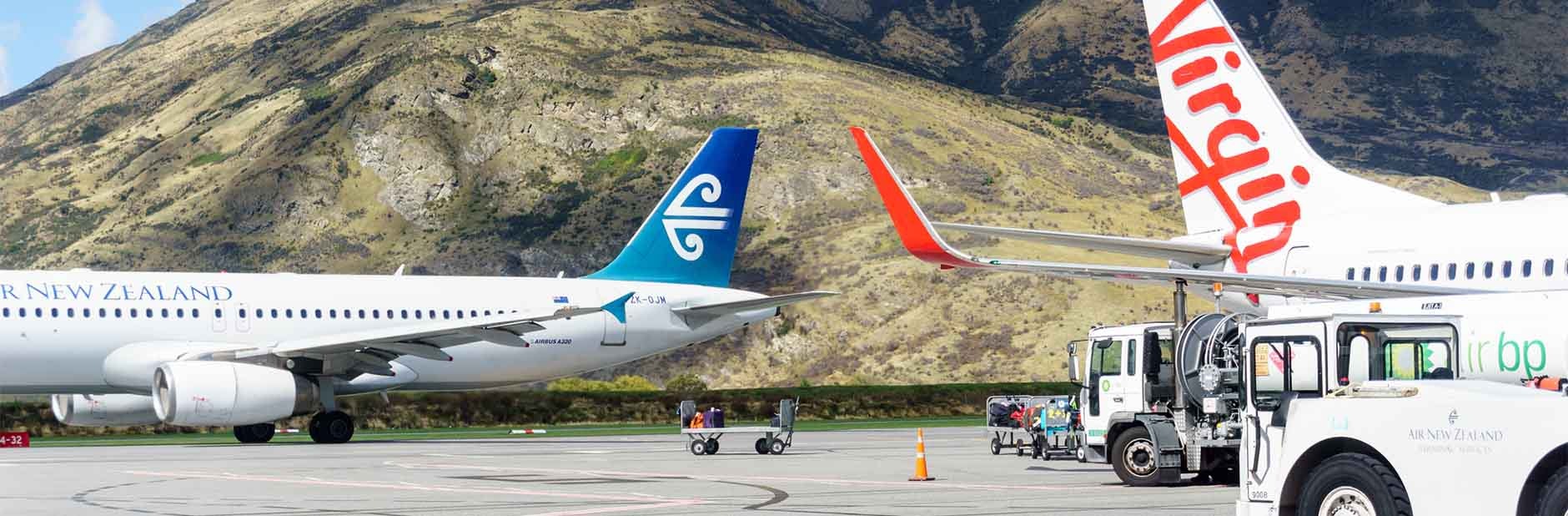 Air New Zealand and Virgin airplanes on tarmac.