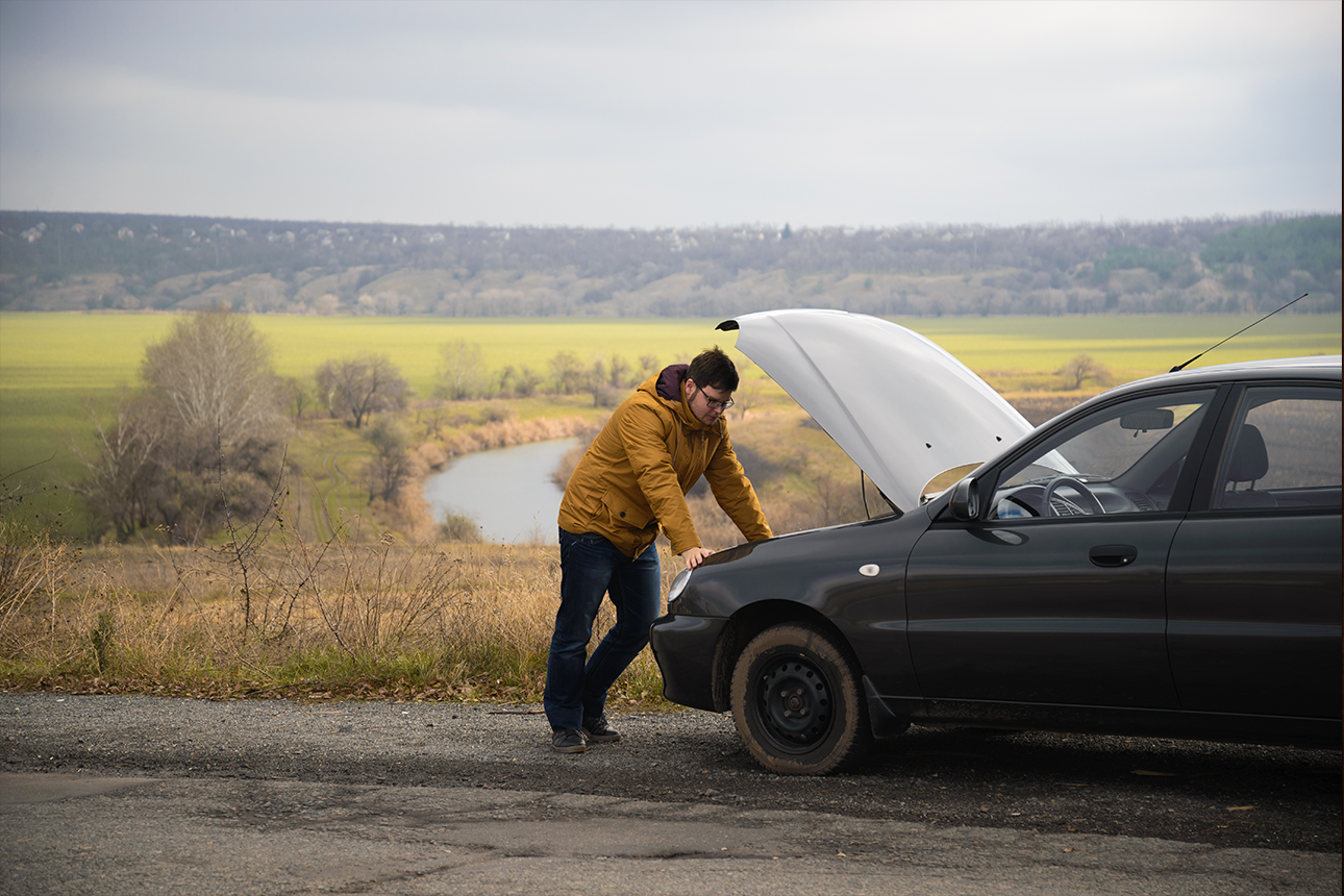 Car broken down on the side of the road.