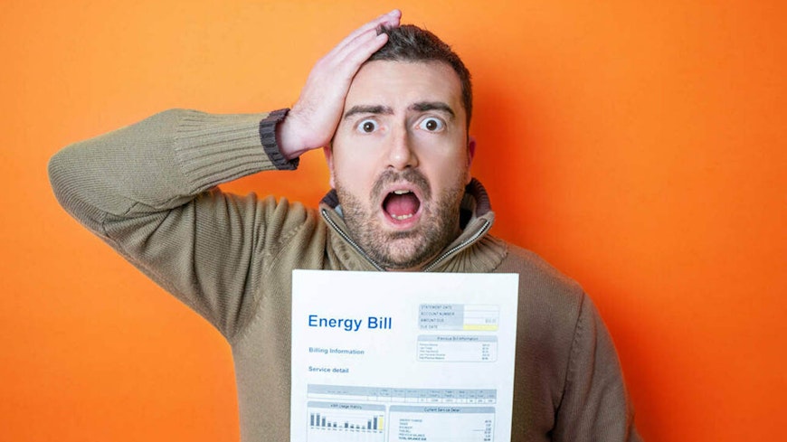 man holding energy bill