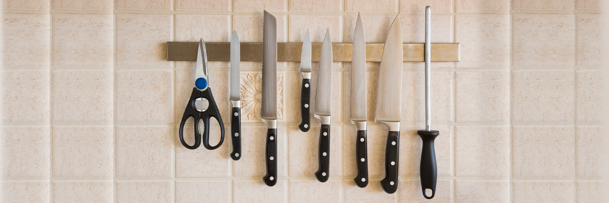 Kitchen knives on a magnetic rack.