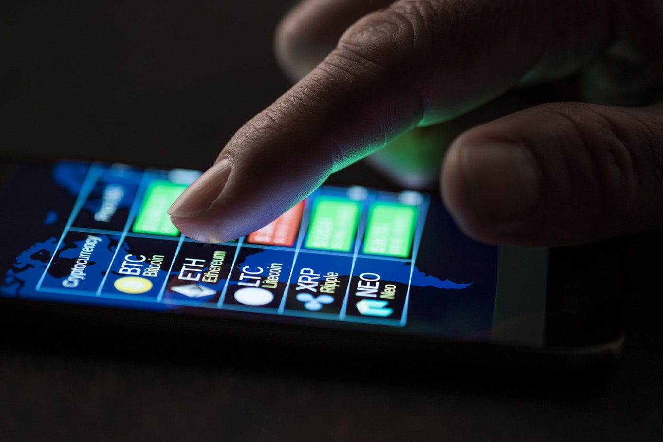 Man checking cryptocarrencies exchange to dollar rate on smartphone display.