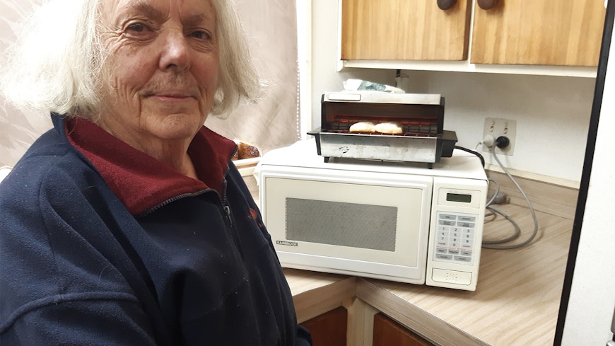 Lady next to old toaster.