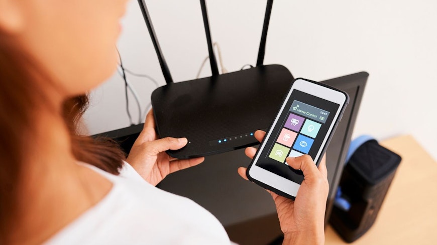 A woman connects her wifi router in her home