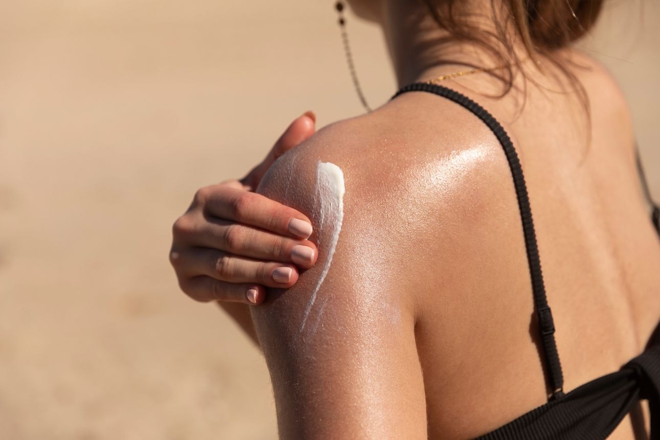 Photo of woman applying sunscreen