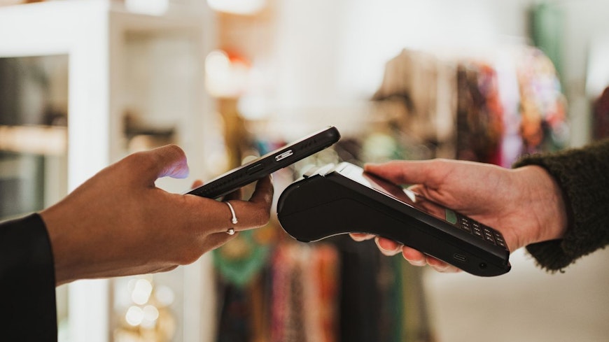 Consumer nz website promo image a shopper uses their phone to pay width