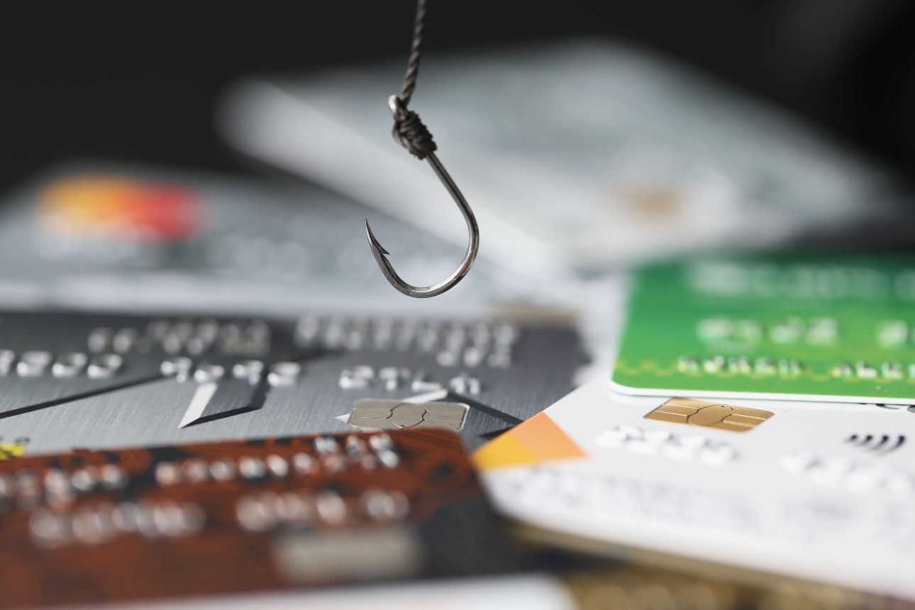 Image of a fishing hook over bank cards