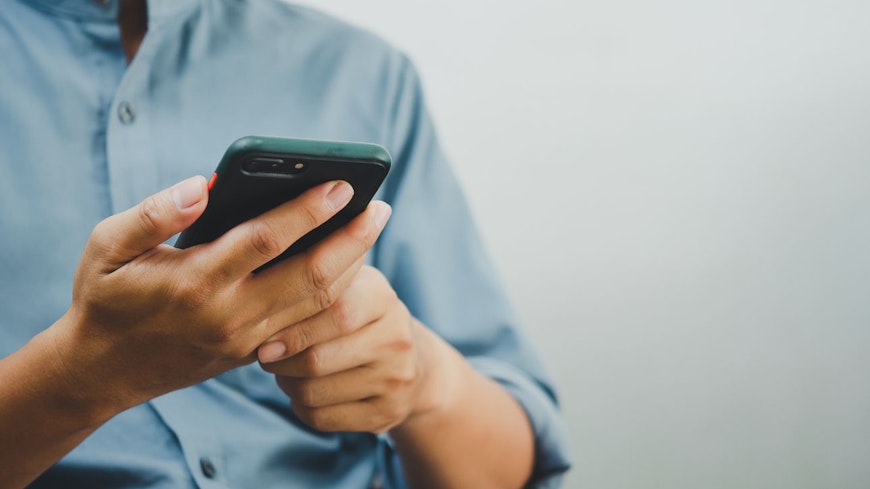 Image of a man holding a phone