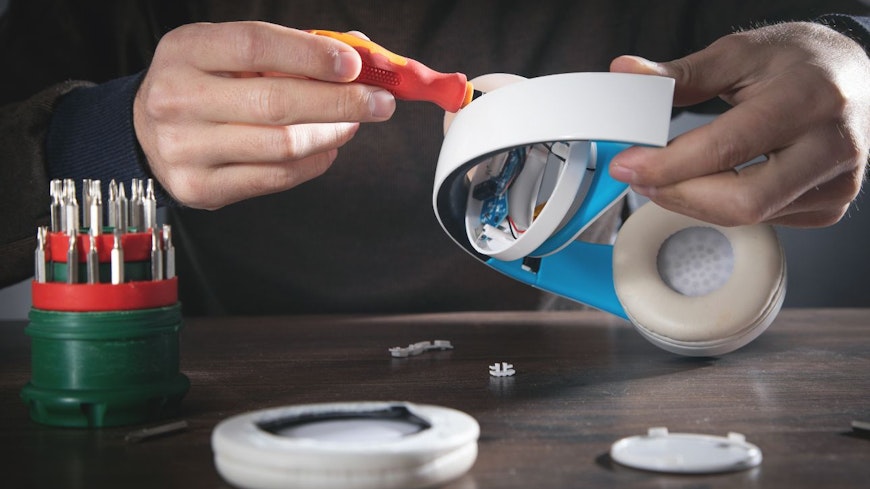 Image of a man repairing headphones
