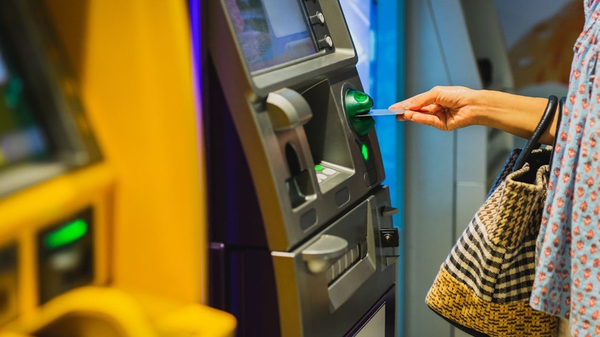 Image of a woman using an ATM machine