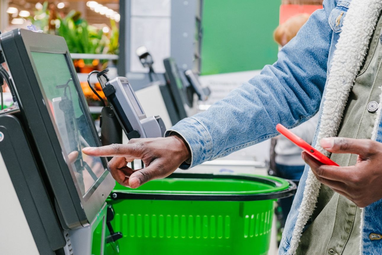 Image of a guy at the supermarket self check out