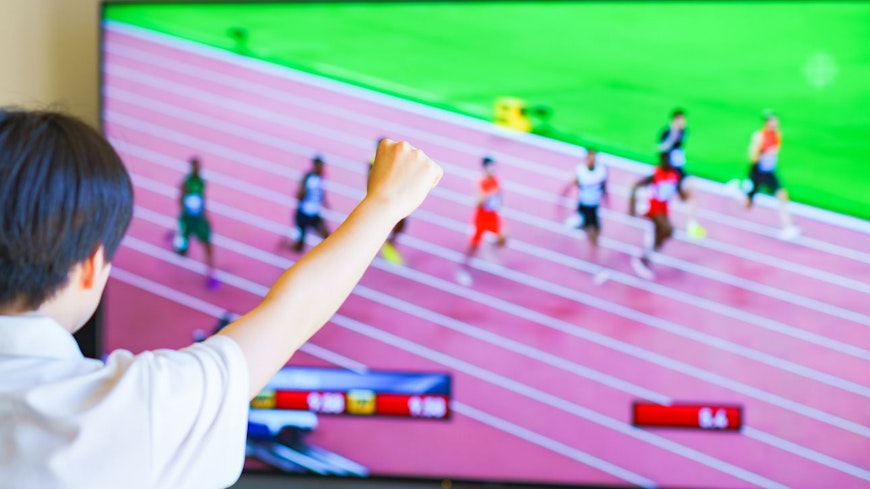 Image of a boy watching sports on the TV
