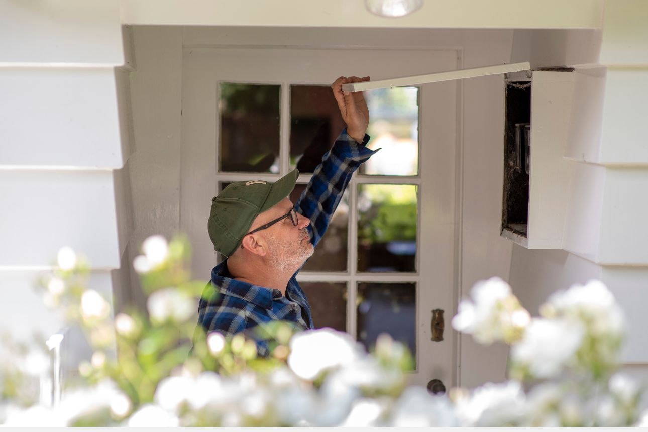 Image of a man opening circuit box