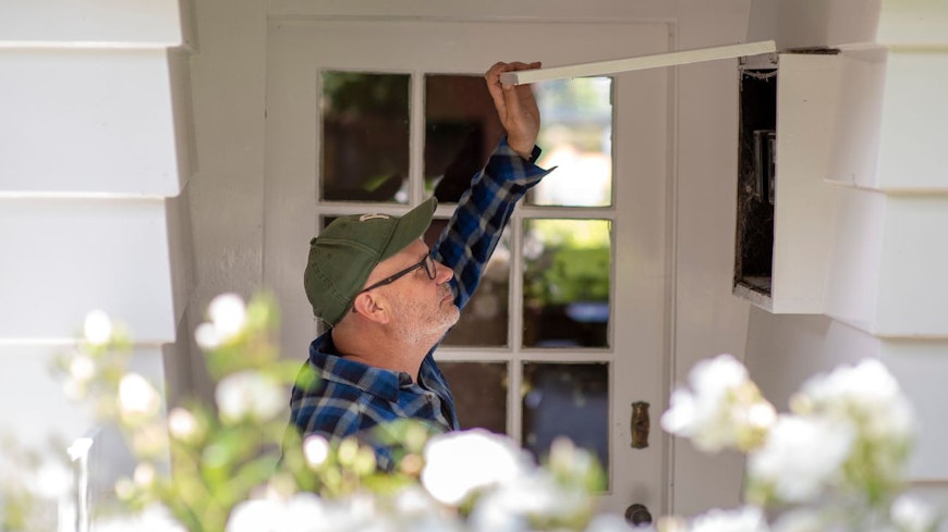 Image of a man opening circuit box