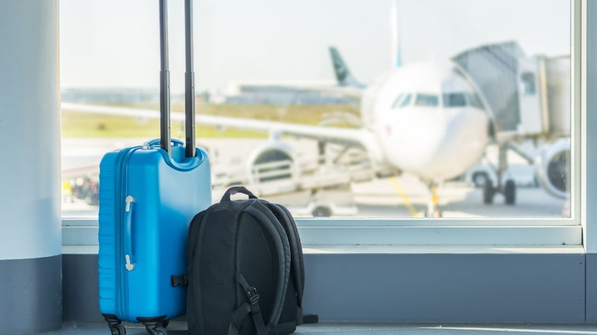 Image of luggage by an airport window