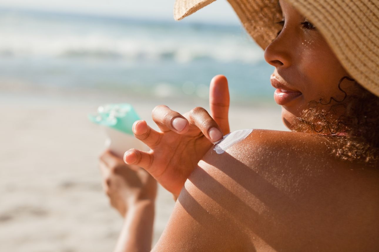 Woman applying sunscreen