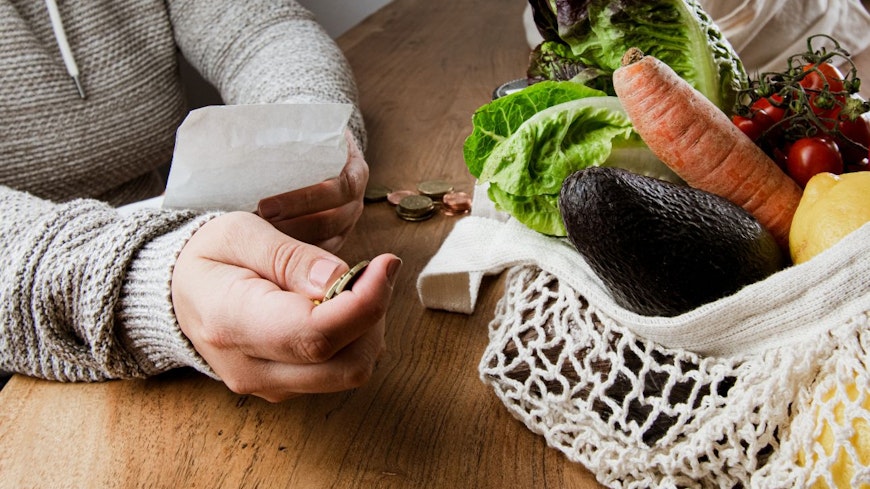 Woman looking at supermarket receipt
