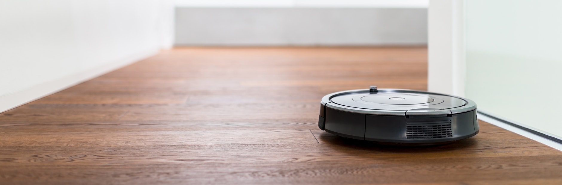 Robot vacuum cleaner in hallway.