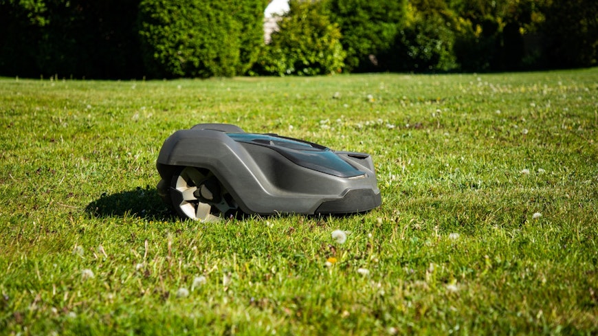 Robot lawn mower on grass.