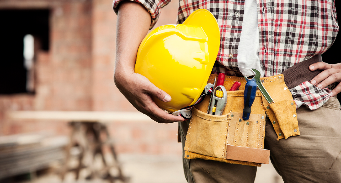 Close up picture of builder with tool belt.