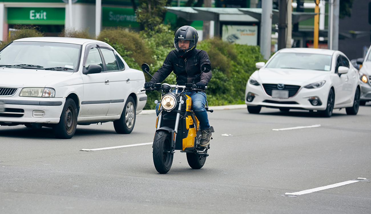 Person riding e-moped in town.