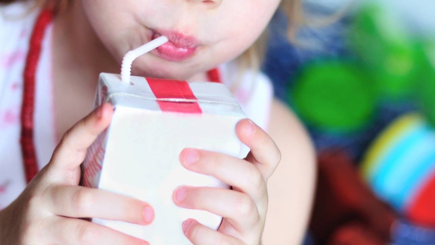 Image of a baby drinking a juice box