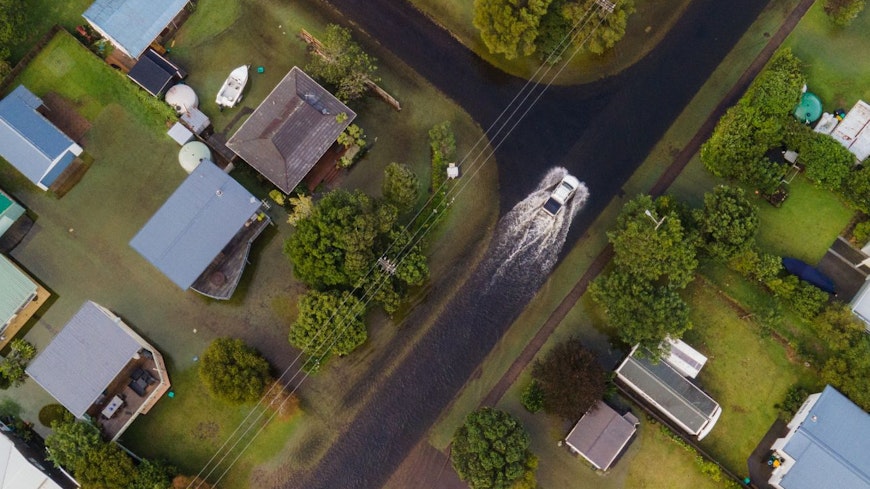 Image of a car driving through floods