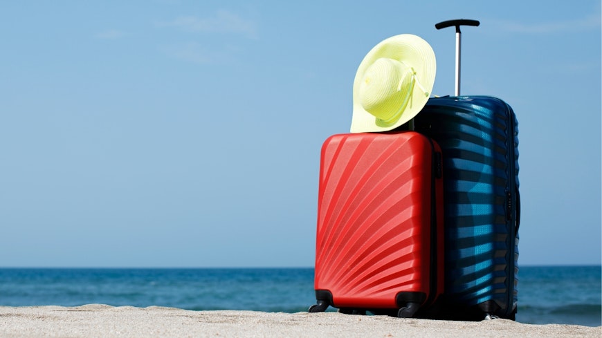 Image of suitcases on a beach