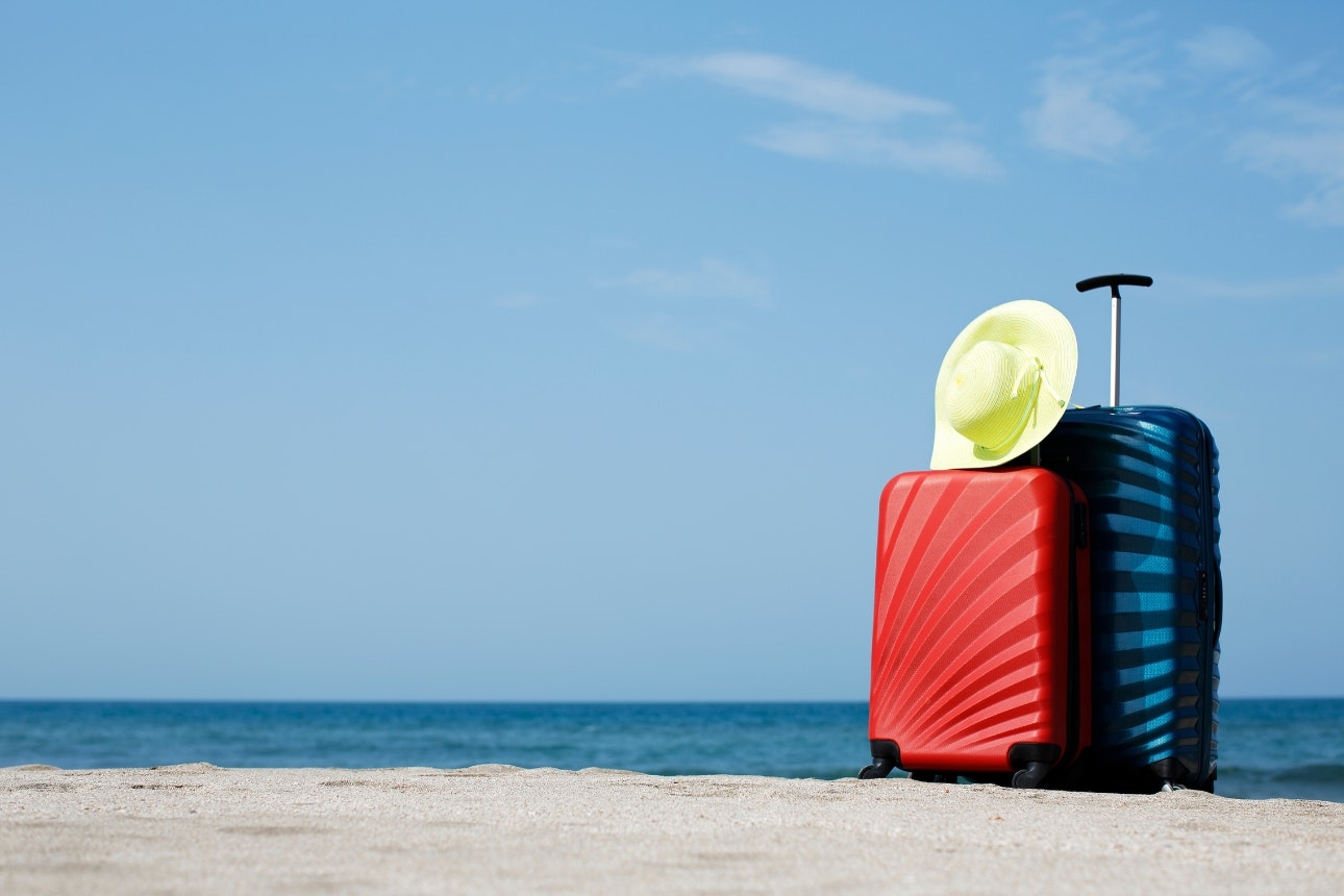 Image of suitcases on a beach