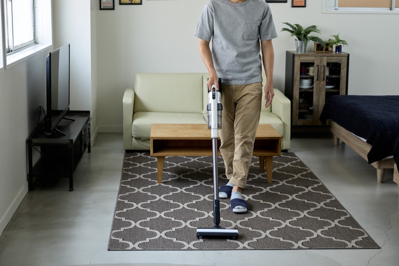 Stick vaccuum on carpet.