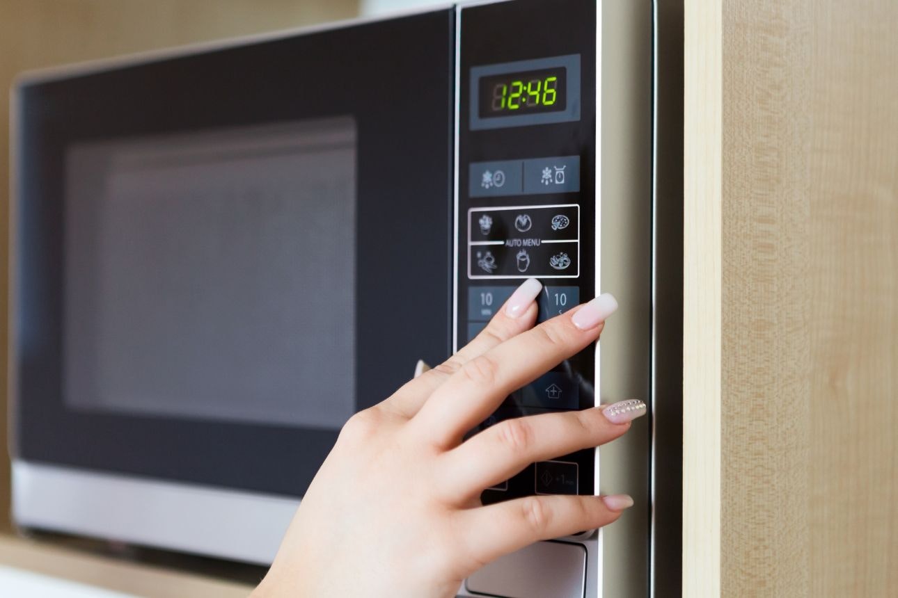 Person using microwave.