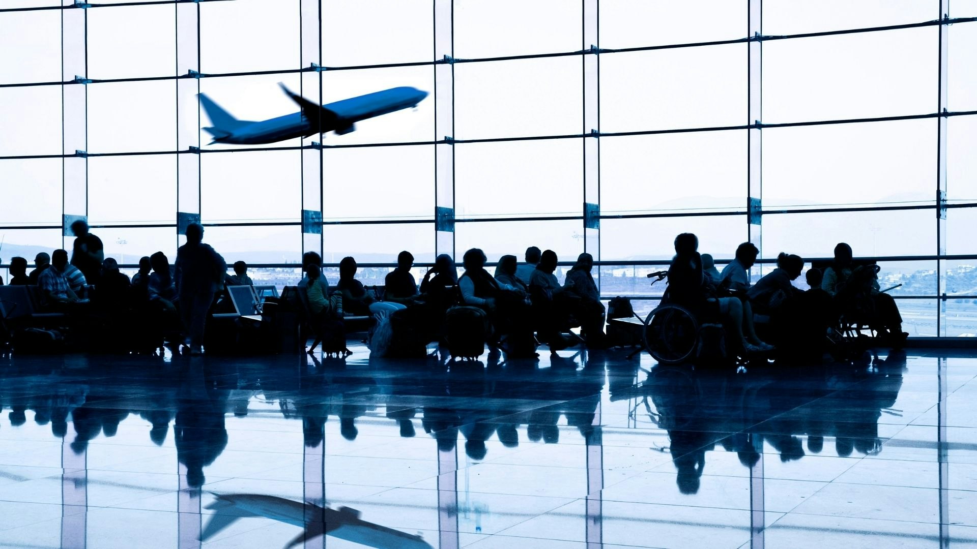Travellers waiting at an airport.